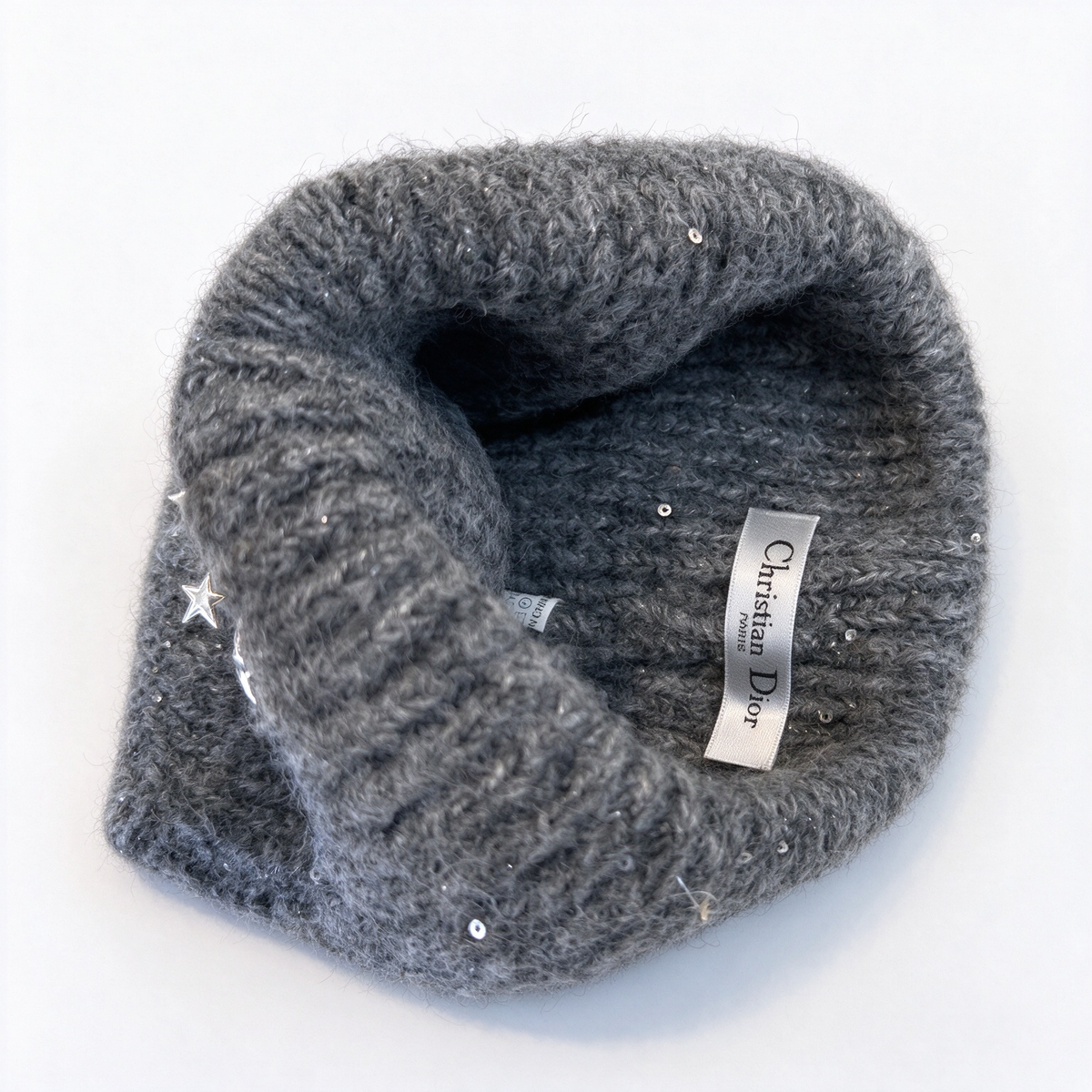 Dior "Starlight" collection sequined knit beanie—crafted from a charcoal-grey wool blend and embellished with metallic stars and a gold-tone Dior logo; a winter knit hat designed for women.